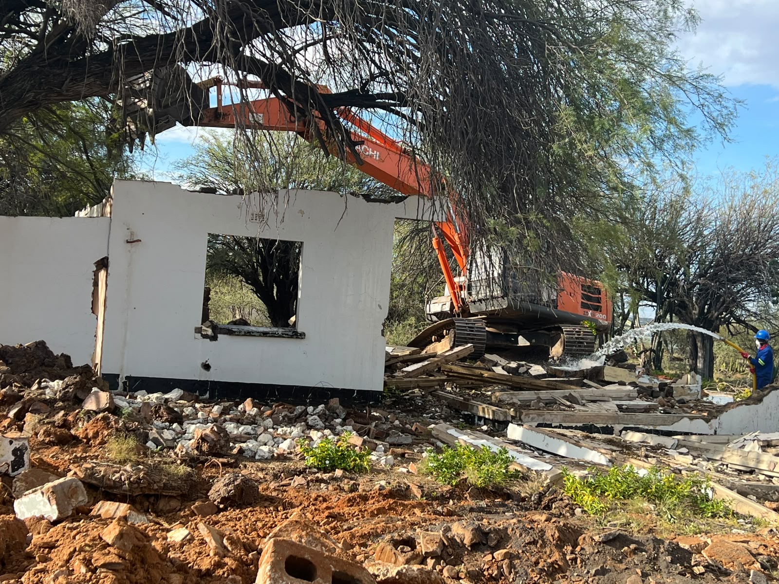 Excavator demolition with water suppression